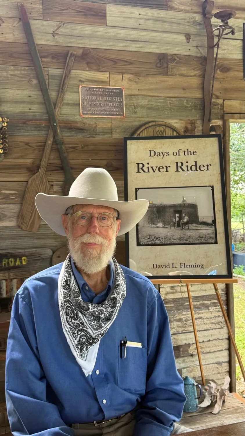 David Layton Fleming beside a Days of the River Rider book display
